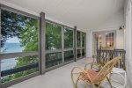 Upper level screen porch with outdoor furniture to relax and take in the view